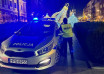"Policjant stoi przy radiowozie"